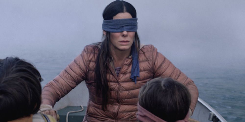 A blindfolded Malorie rowas a boat with two children in Bird Box