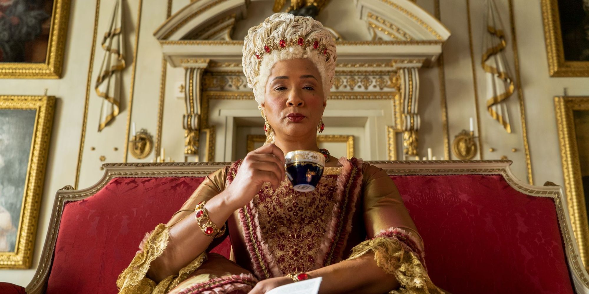 Queen Charlotte drinking tea and looking haughty in Bridgerton.