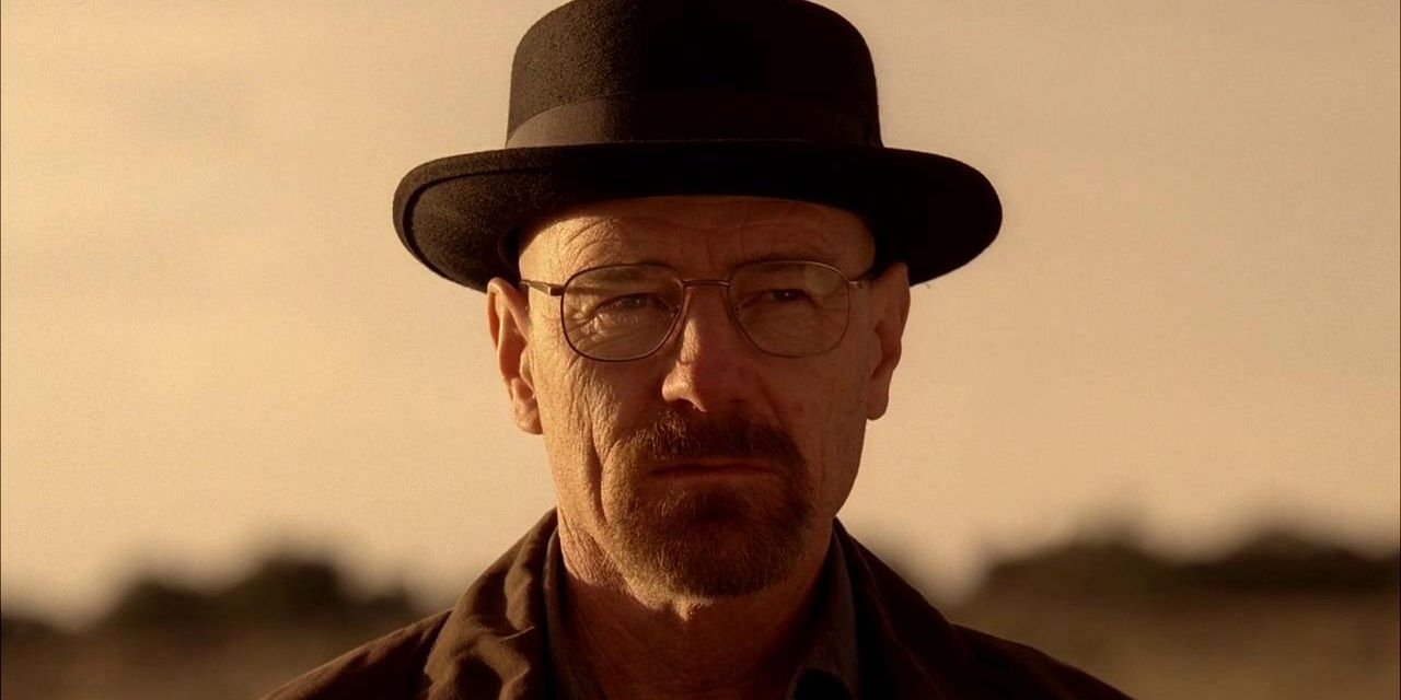 Bryan Cranston wears a hat and looks in the distance in Breaking Bad.