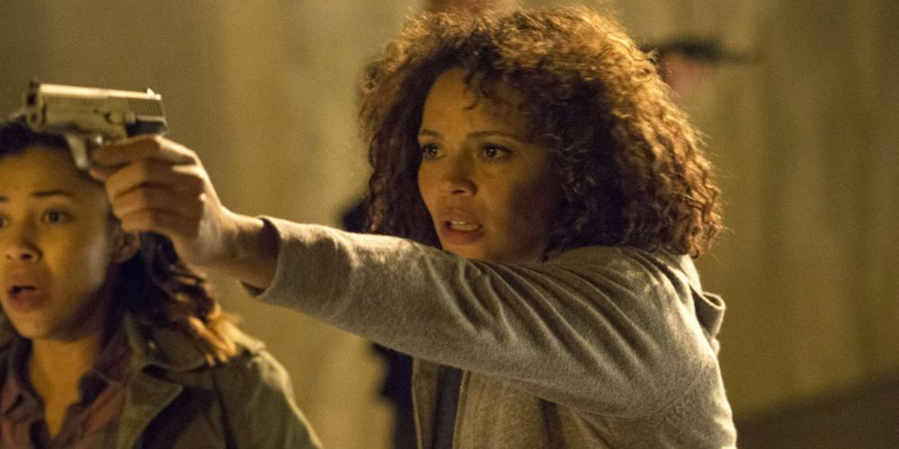 Carmen Ejogo's character Eva holding a gun in The Purge: Anarchy