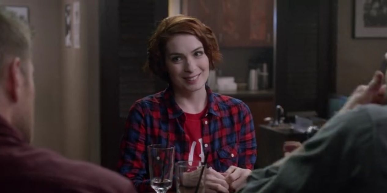 Charlie smiling, sitting with Winchesters in Supernatural