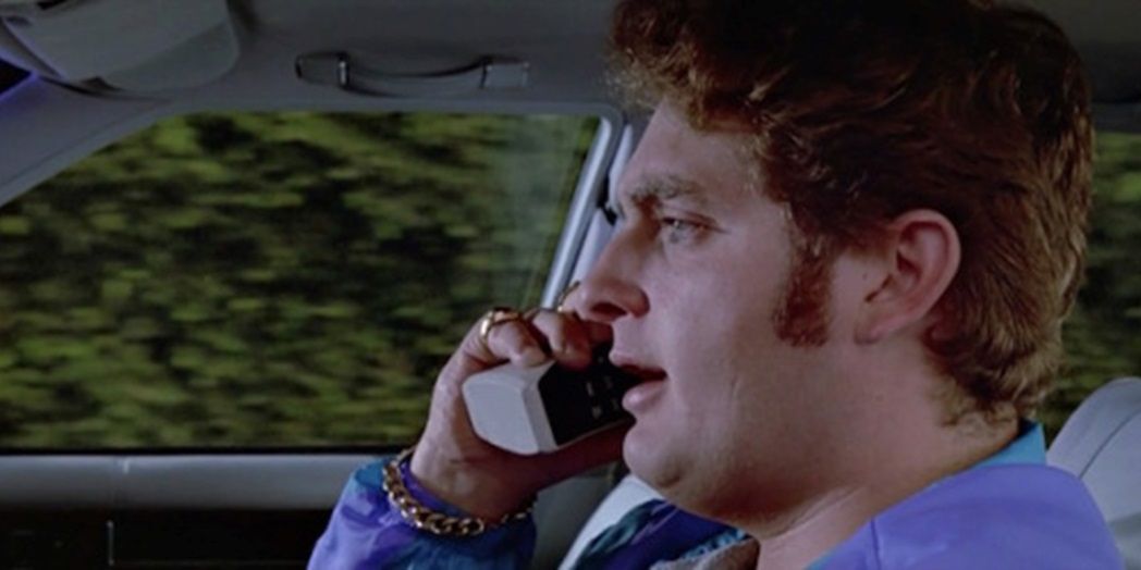 Chris Penn driving a car in Reservoir Dogs
