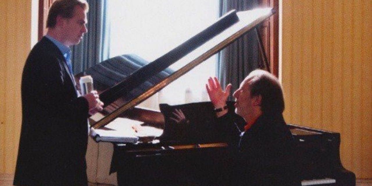 Christopher Nolan and Hans Zimmer talk by a piano