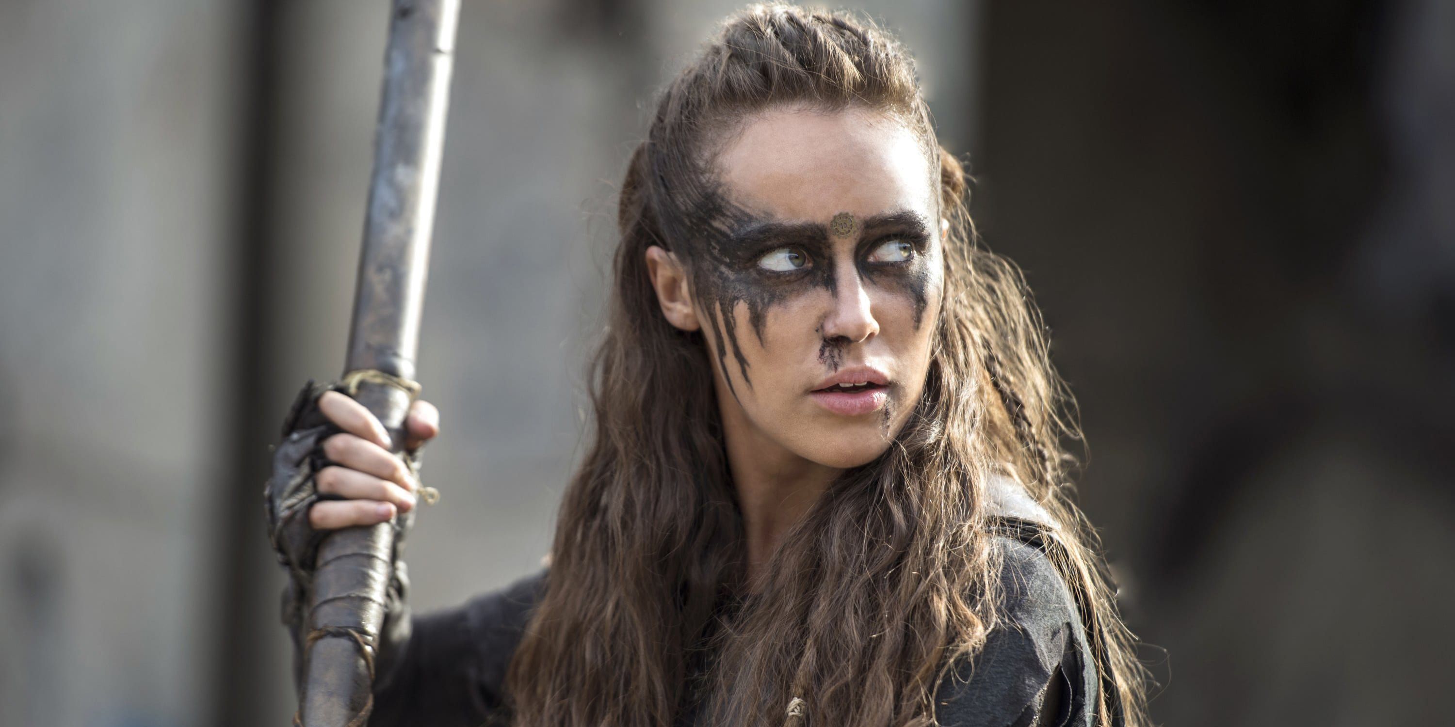 Lexa in a fighting stance holding a weapon
