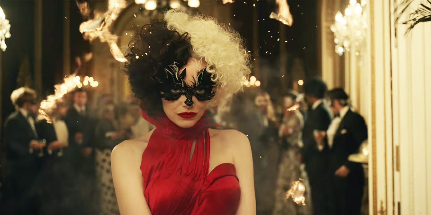 Cruella lights her cape on fire and reveals her red dress