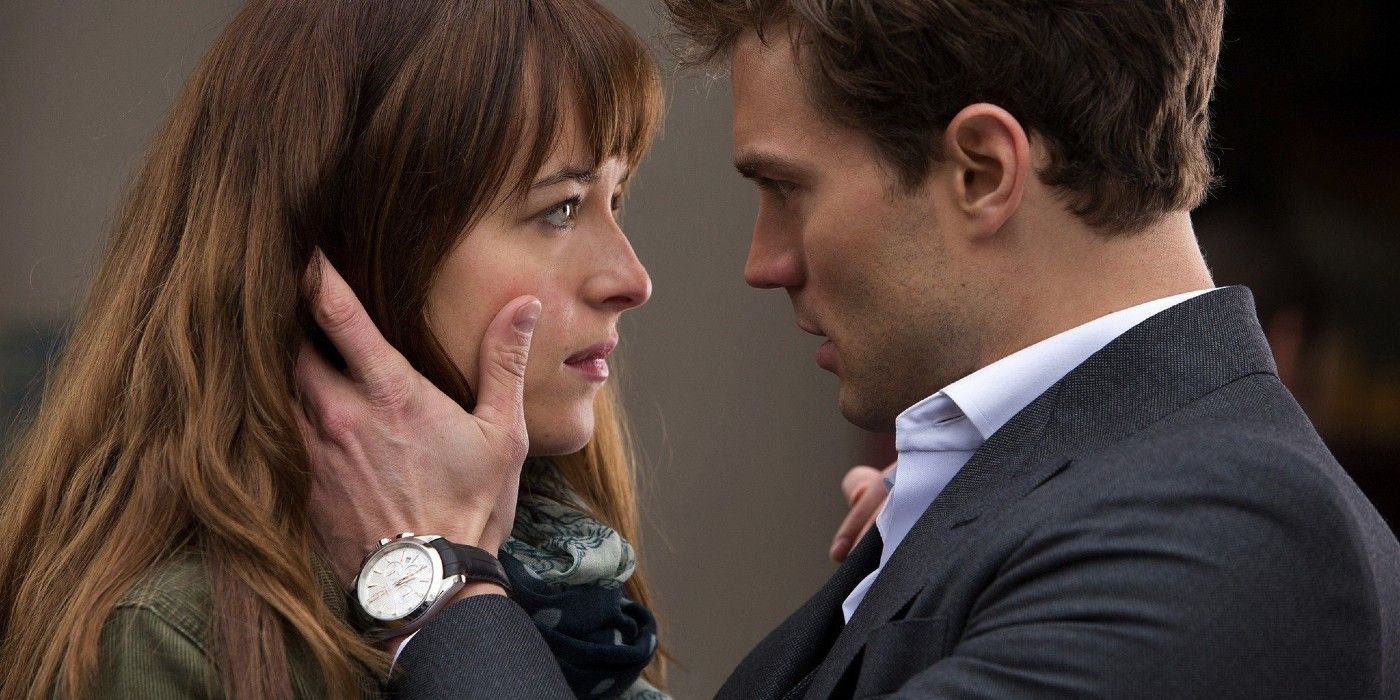 Christian Grey holds Anastasia Steele's face in his hands in 50 Shades of Grey