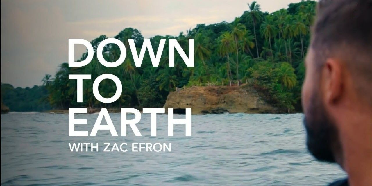 Zac Efron looking out over water in title screen of Down to Earth with Zac Efron