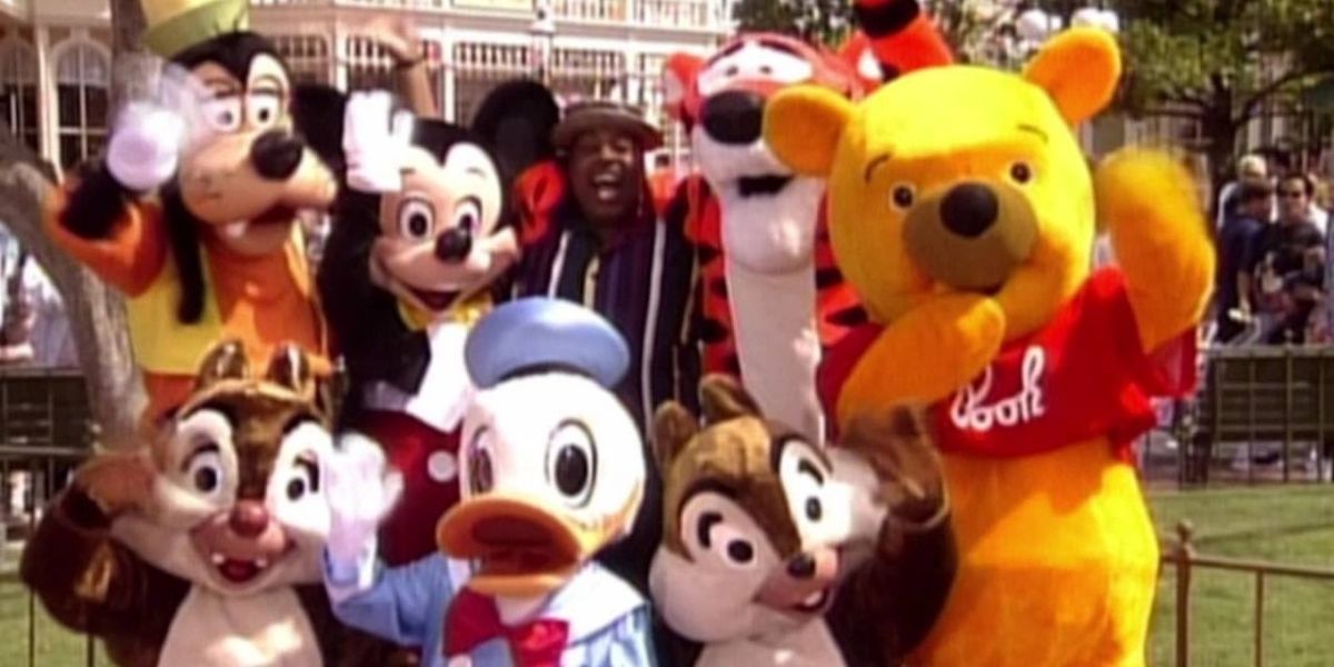 Carl Winslow poses with Goofy, Mickey, Tigger, Winnie the Pooh, Donald Duck, Chip, and Dale.