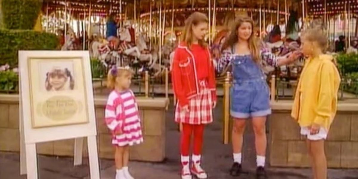 The Tanner sisters and Kimmy in front of the Carousel at Magic Kingdom. 