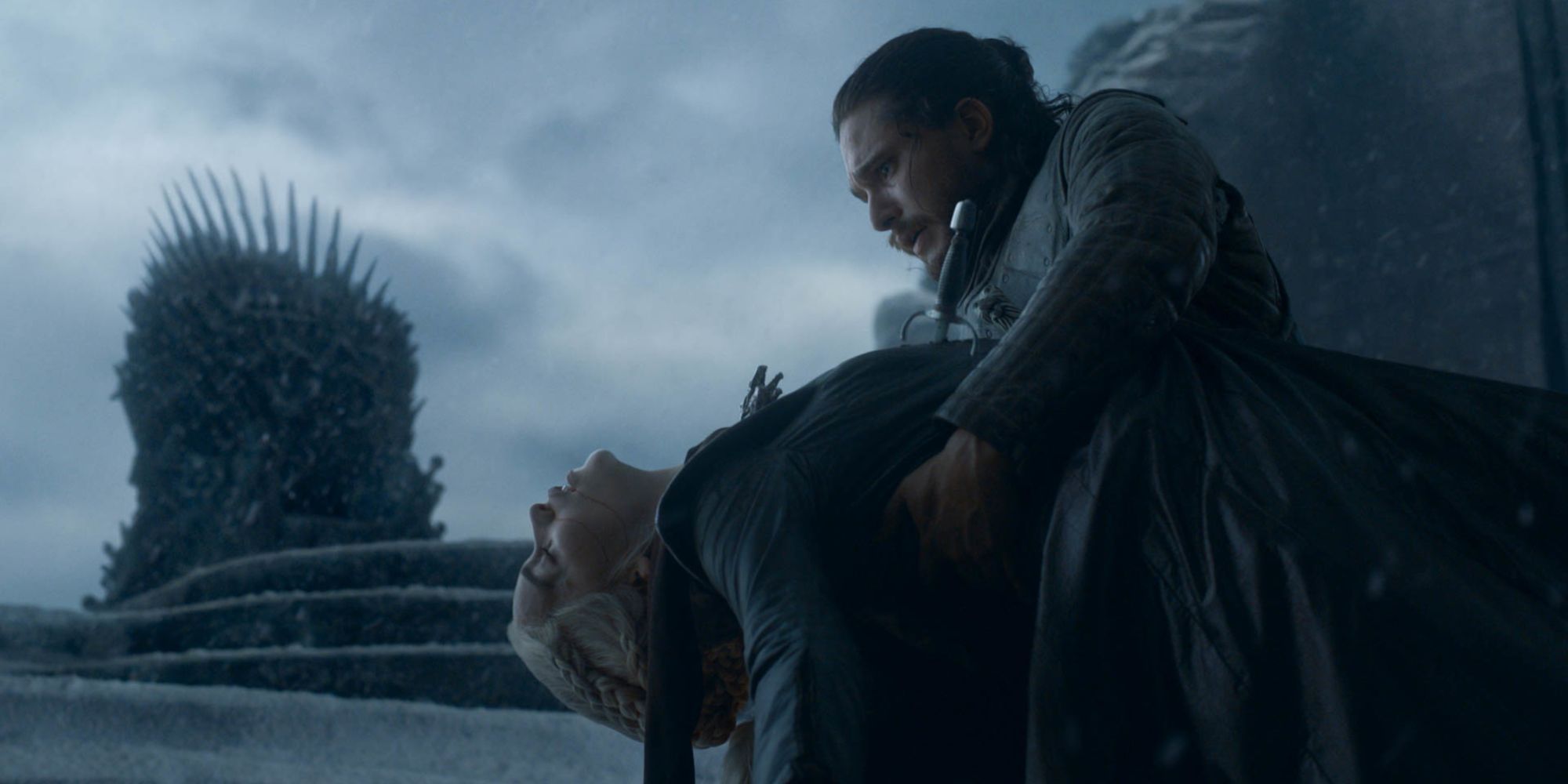 Jon Snow holding Daenerys' dead body in front of the Iron Throne in Game of Thrones' series finale
