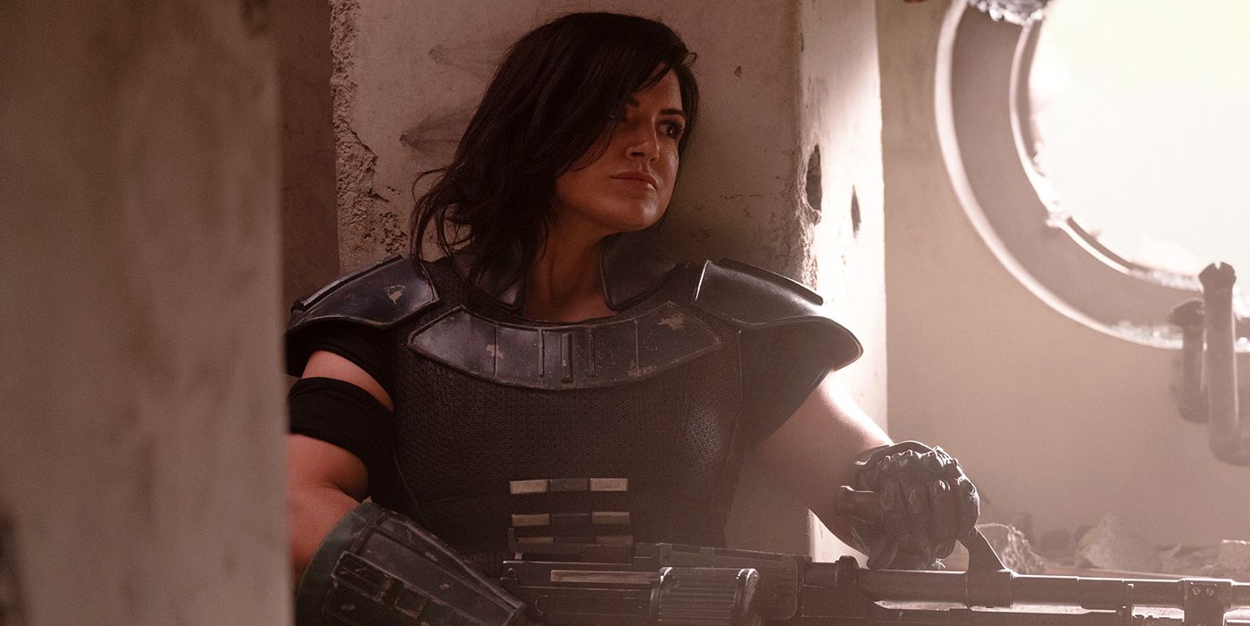 Gina Carano as Cara Dune ready to fire her gun in The Mandalorian.
