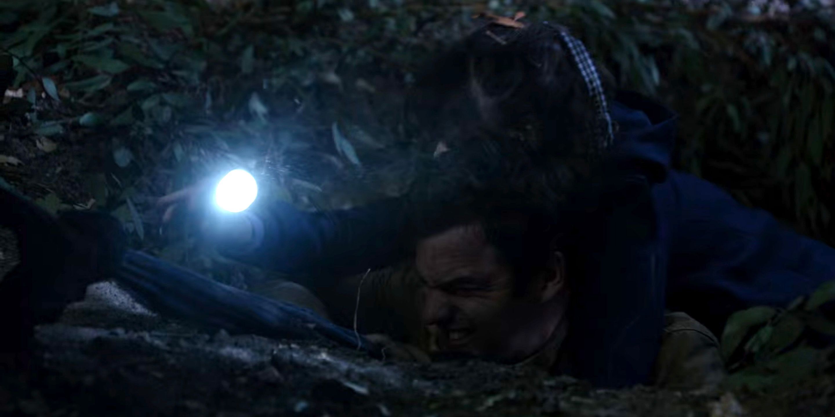 A stressed Nick in a hole with his flashlight
