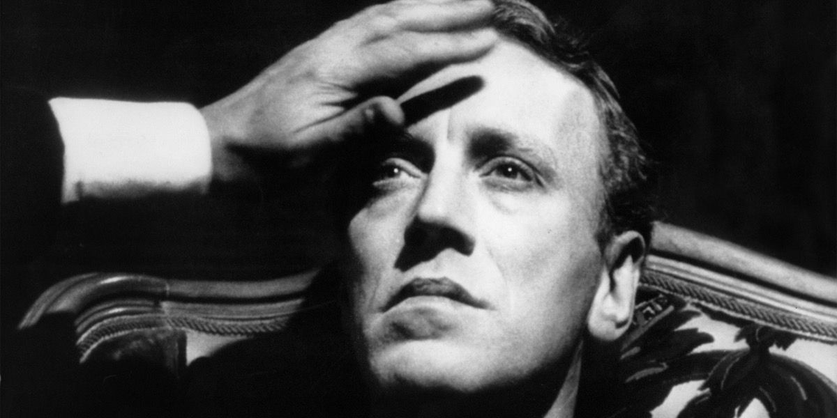 A hand reaches out for a man&rsquo;s forehead from Hour of the Wolf