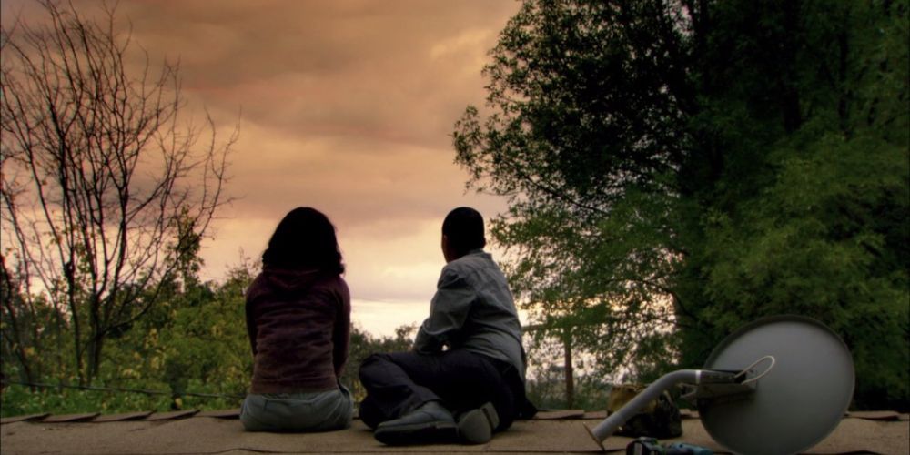 Two characters sitting on a roof in Ava DuVernay's film I Will Follow