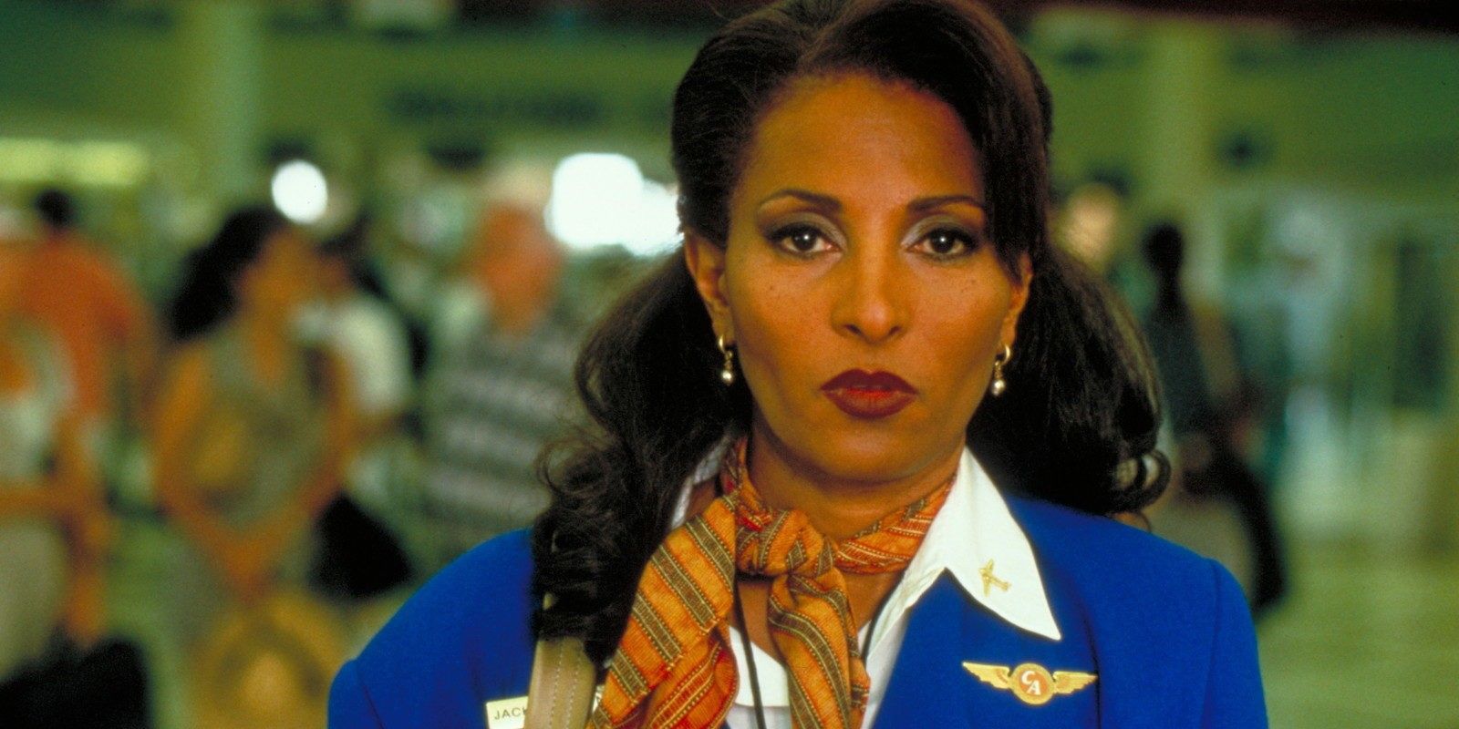 Jackie Brown wears a blue flight attendant jacket
