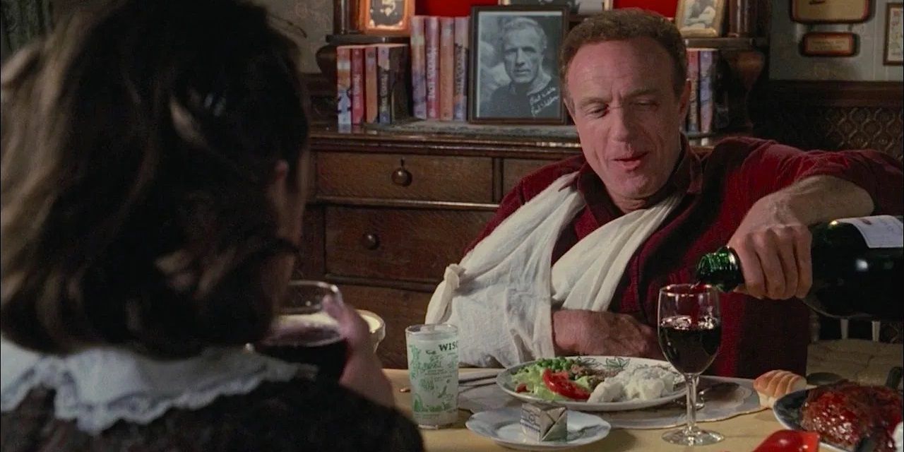 James Caan pouring wine in Misery