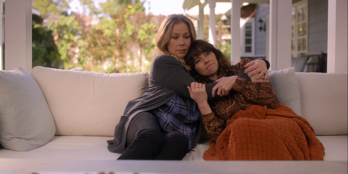Dead to Me's Jen &amp; Judy embracing on a couch