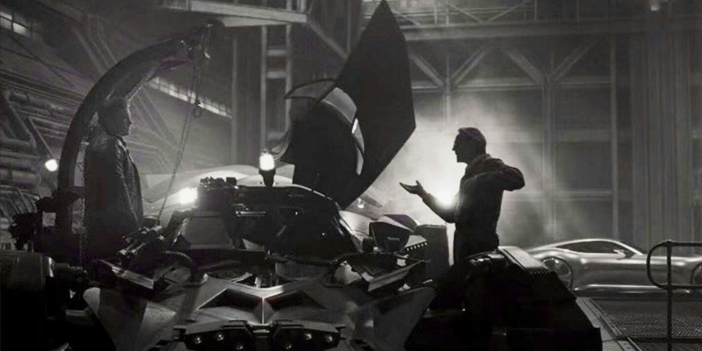 Jeremy Irons as Alfred Justice works with equipment facing Bruce in League Snyder Cut