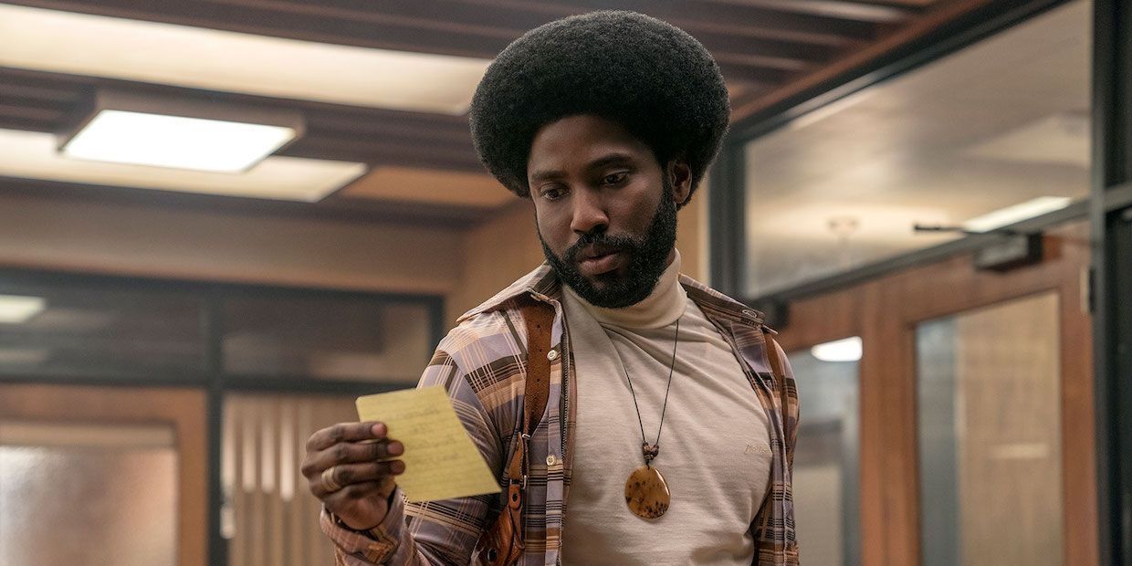 Ron Stallworth looking at a note in BlacKkKlansman