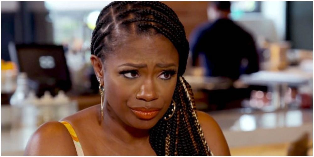 Kandi in a dress and braid looking questioningly at someone on RHOA