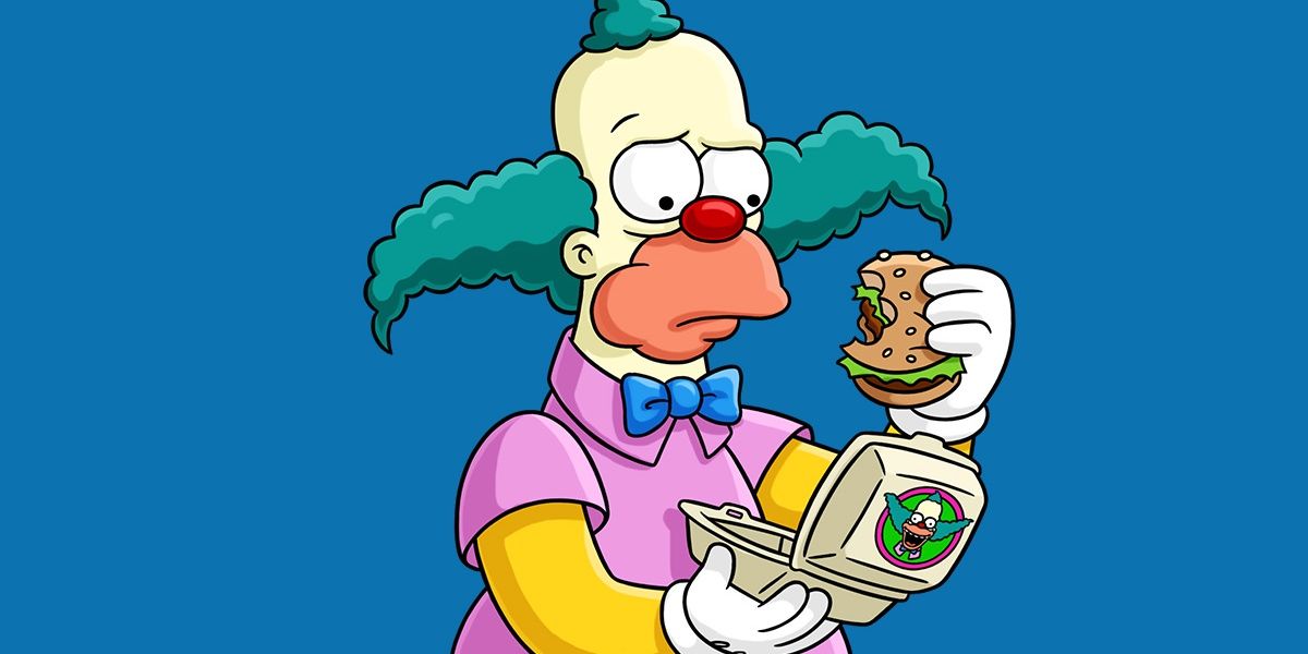 Krusty The Clown holding up a Krusty burger.