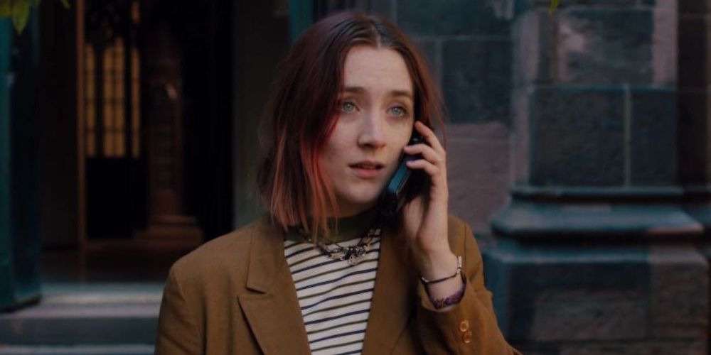 Saoirse Ronan looks annoyed while chatting on a cellphone in Lady Bird.