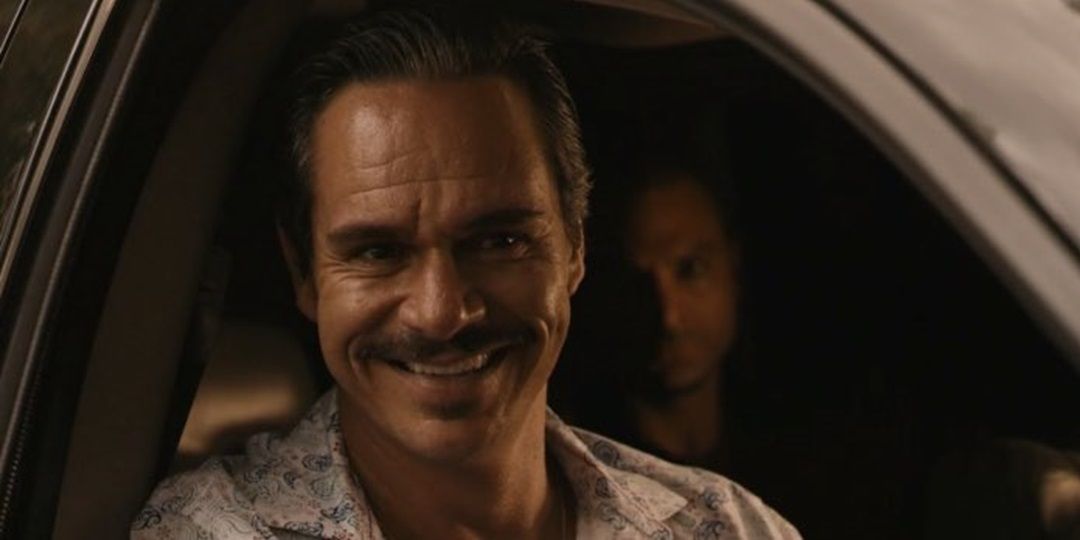 Lalo Salamanca smiling and sticking his head out of the car in Better Call Saul
