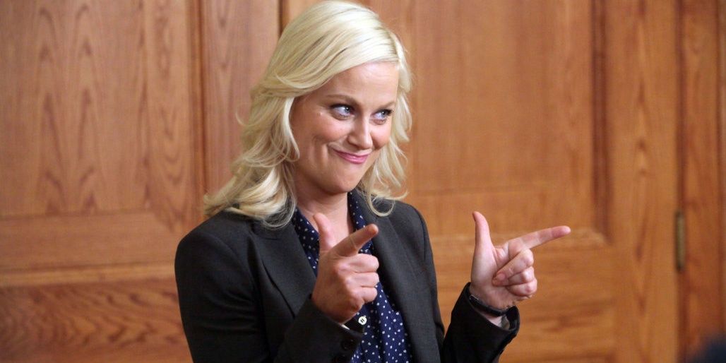 Leslie Knope doing finger guns while wearing a black suit in Parks and Rec