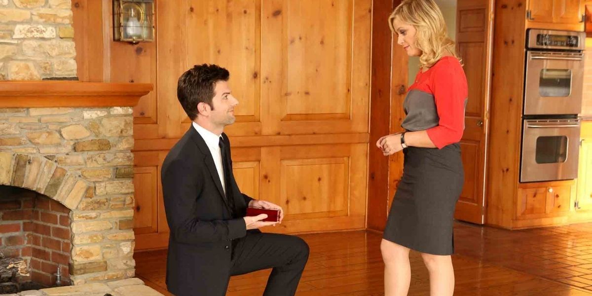 Ben proposing to Leslie in their new home