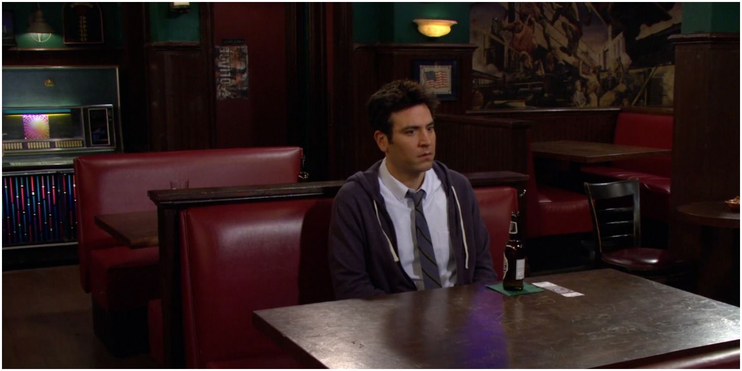 Ted sitting alone at the booth in the bar 