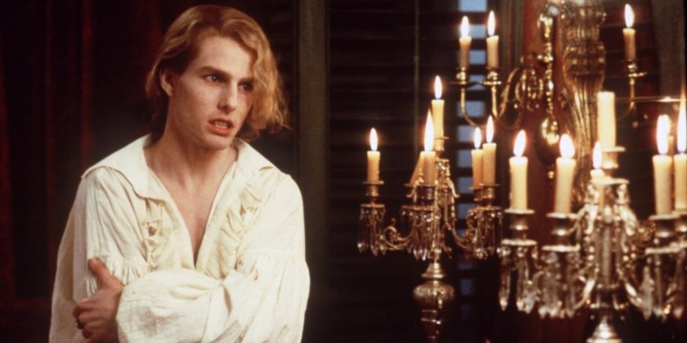 Lestat stands next to candles in Interview With The Vampire