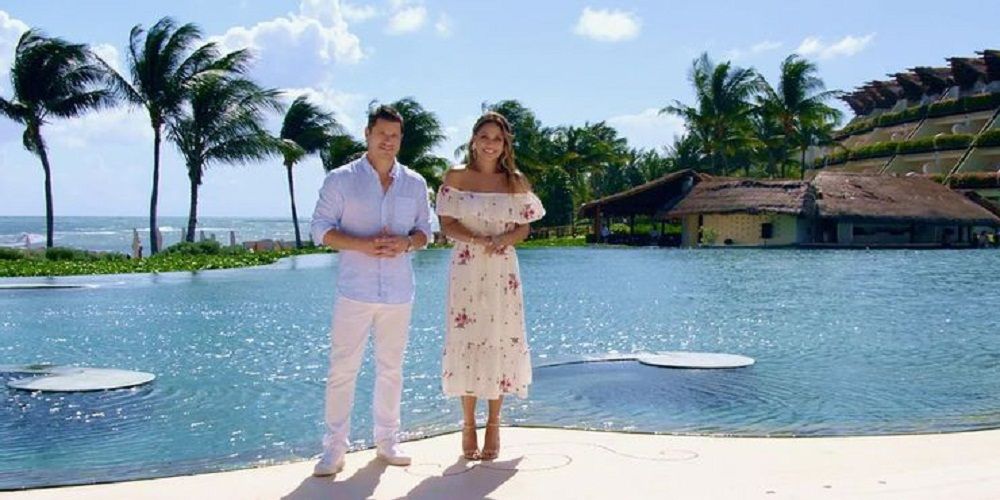 Nick and Vanessa hosting Love is Blind on Netflix, standing by a pool