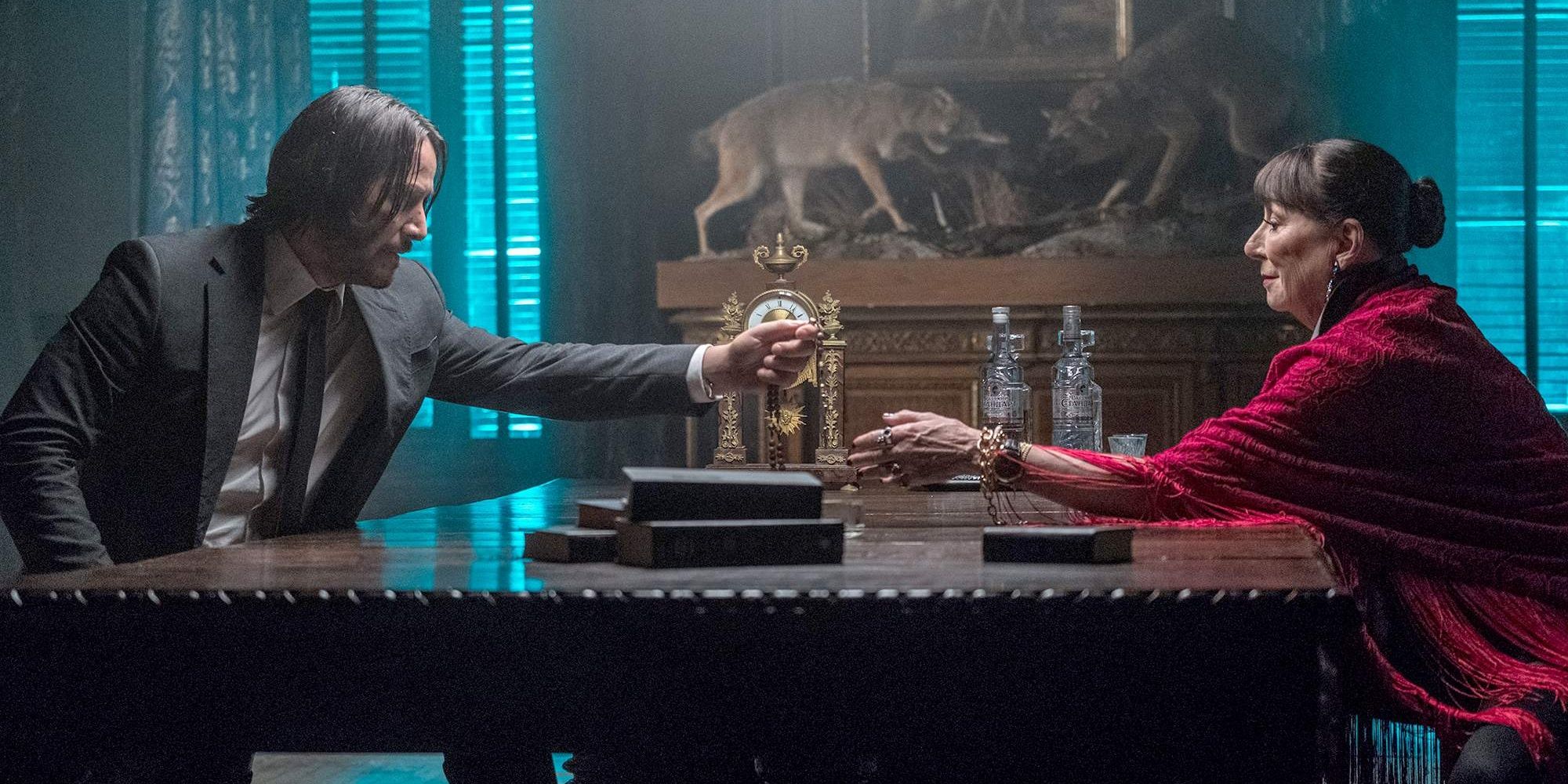 John Wick clinking glasses with woman in a red coat 