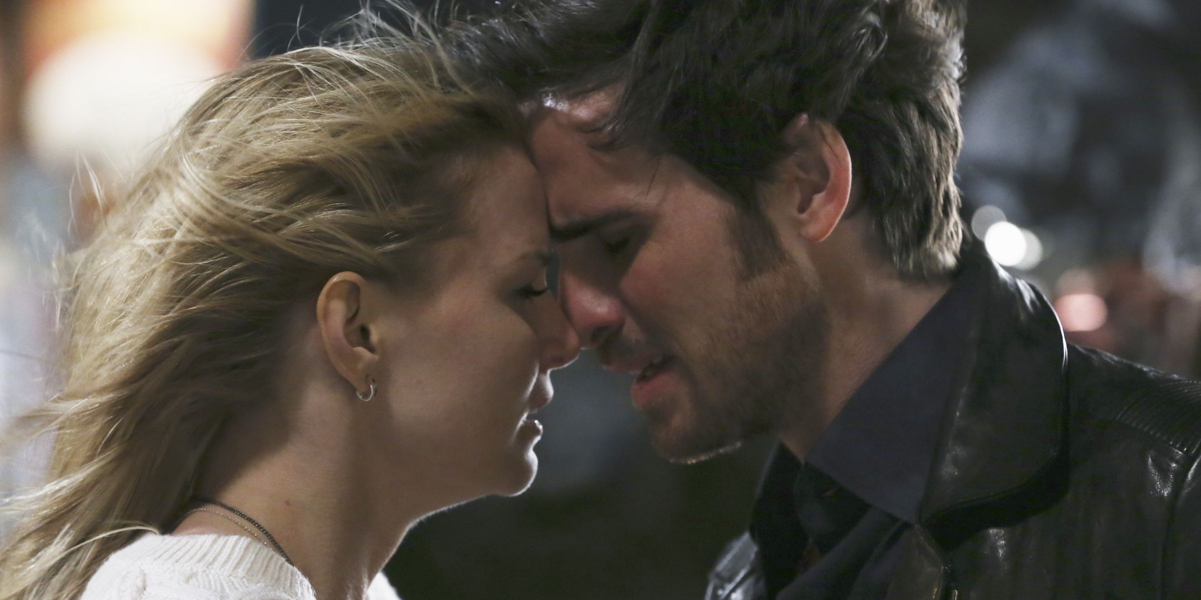 Hook and Emma touching foreheads as their hair flies in Once Upon a Time.