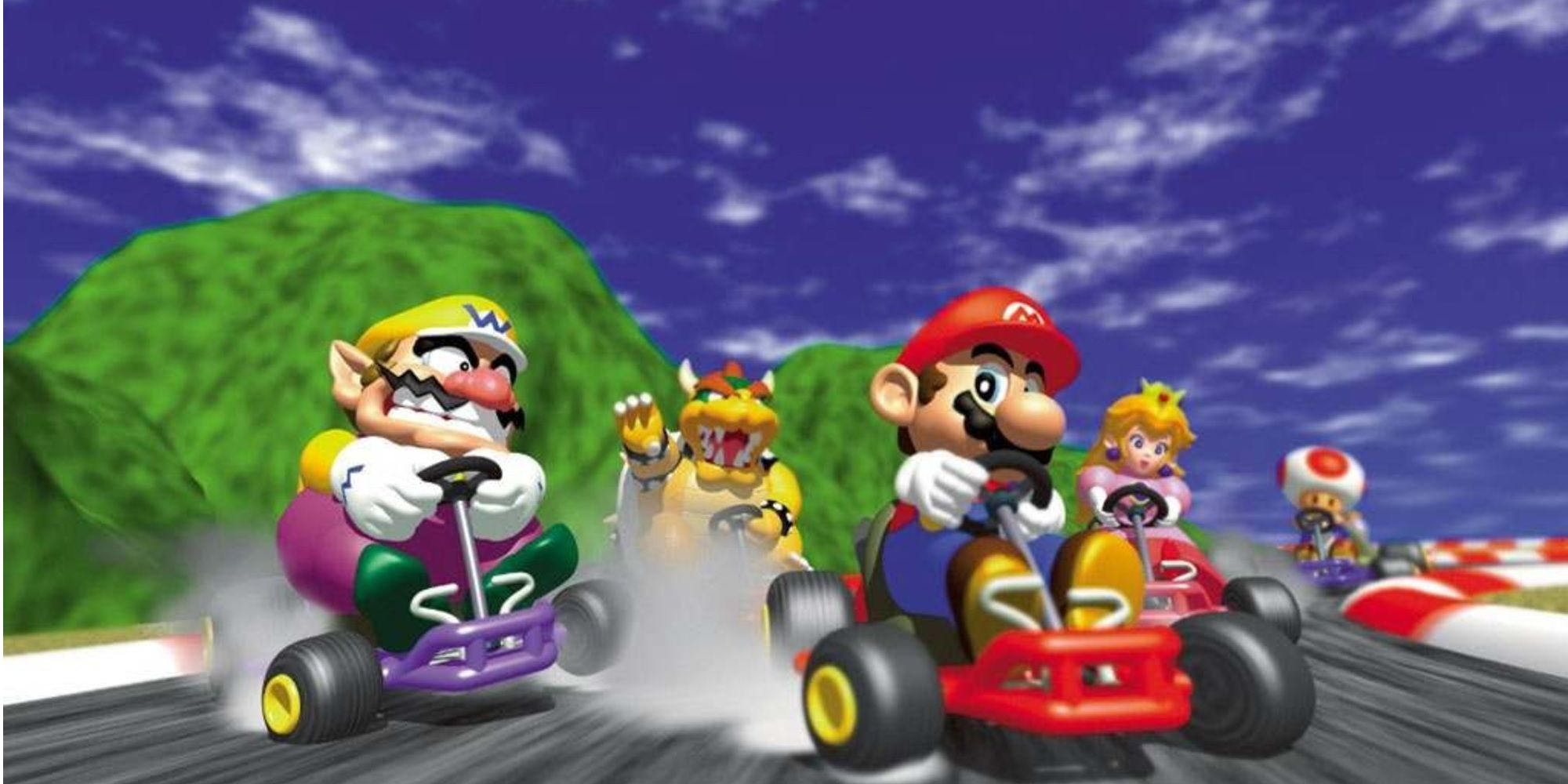 Several Mario characters drive into turn from Mario Kart 64