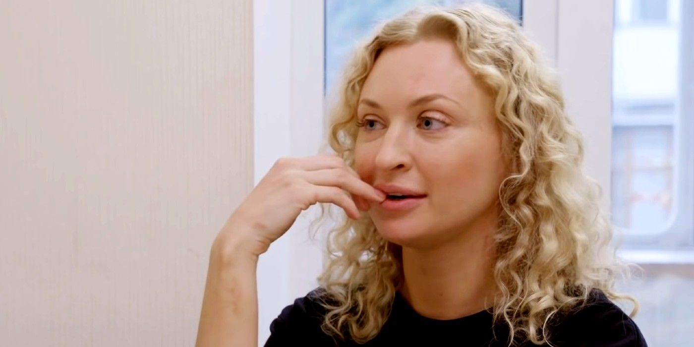 Natalie Mordovtseva In 90 Day Fiance in pensive pose wearing black t-shirt