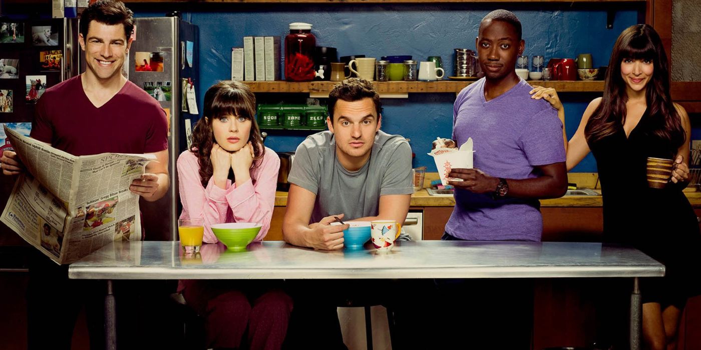 The main cast of New Girl poses in their kitchen.