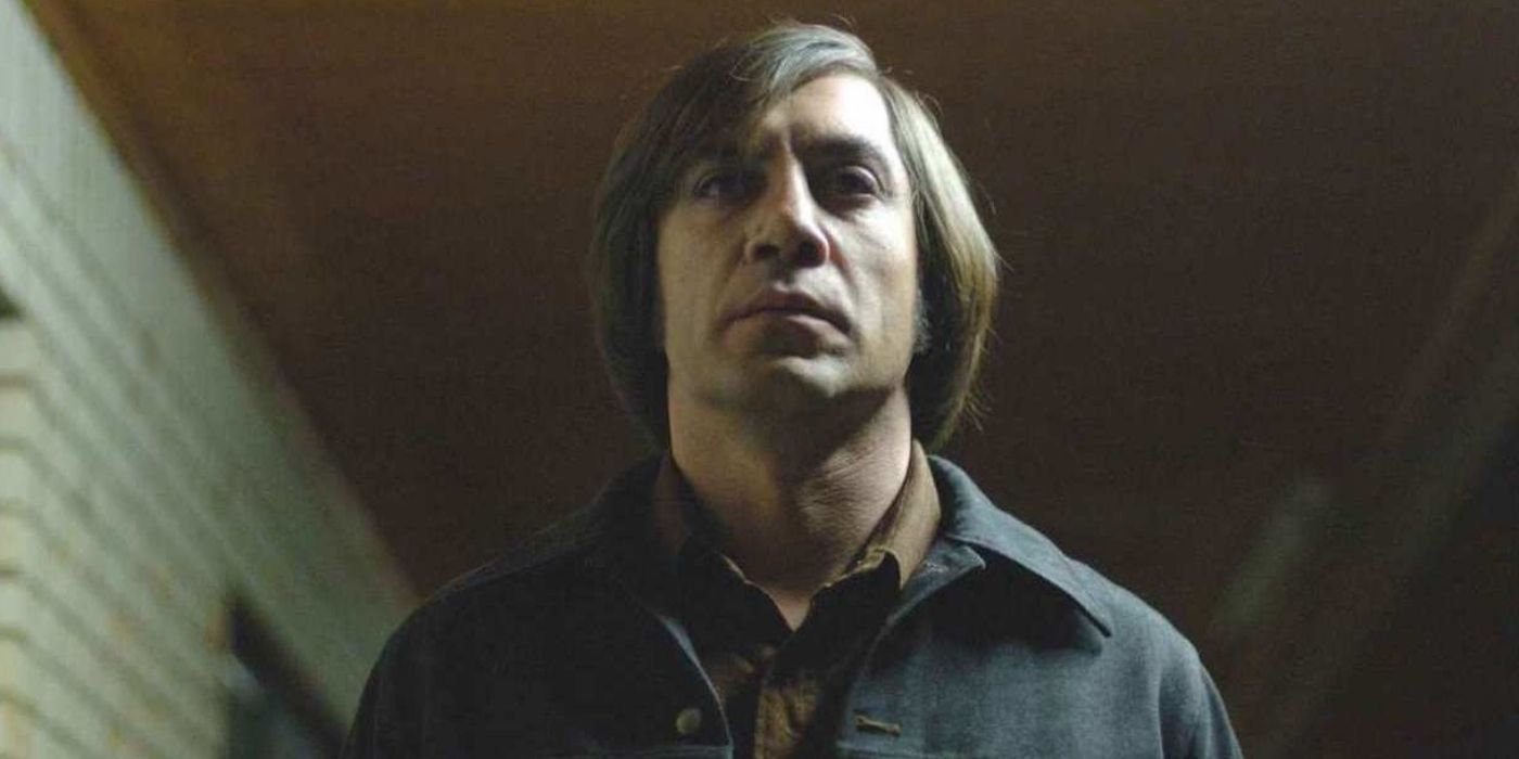Javier Bardem as Anton Chigurgh walking in the shadows in No Country for Old Men (2007)