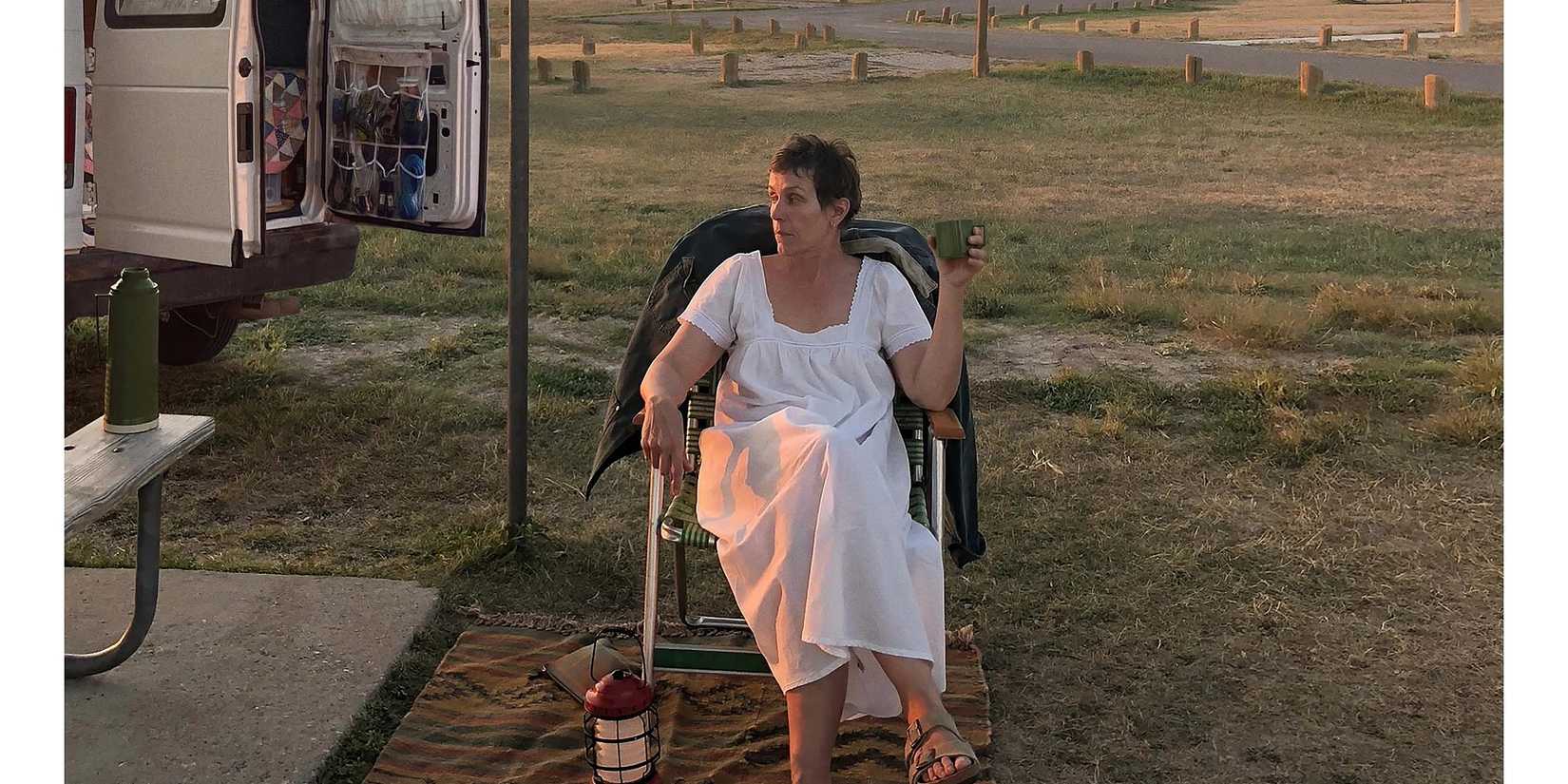 Fern (Francis McDormand) sitting in a chair and smoking in Nomadland.