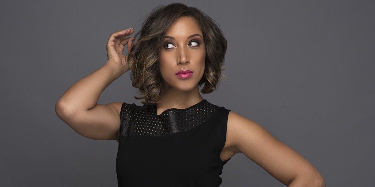 Robin Thede posing against a grey background in a promo image for The Rundown