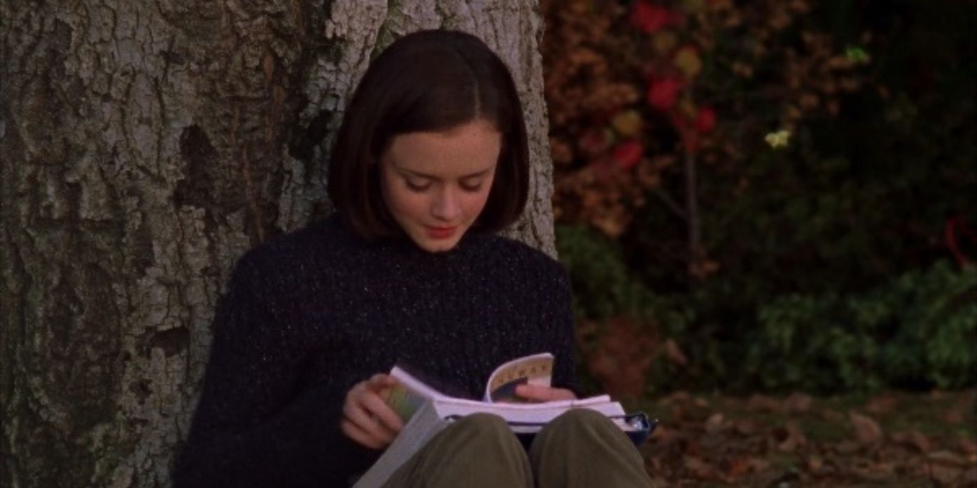 Rory reading a book under tree on Gilmore Girls