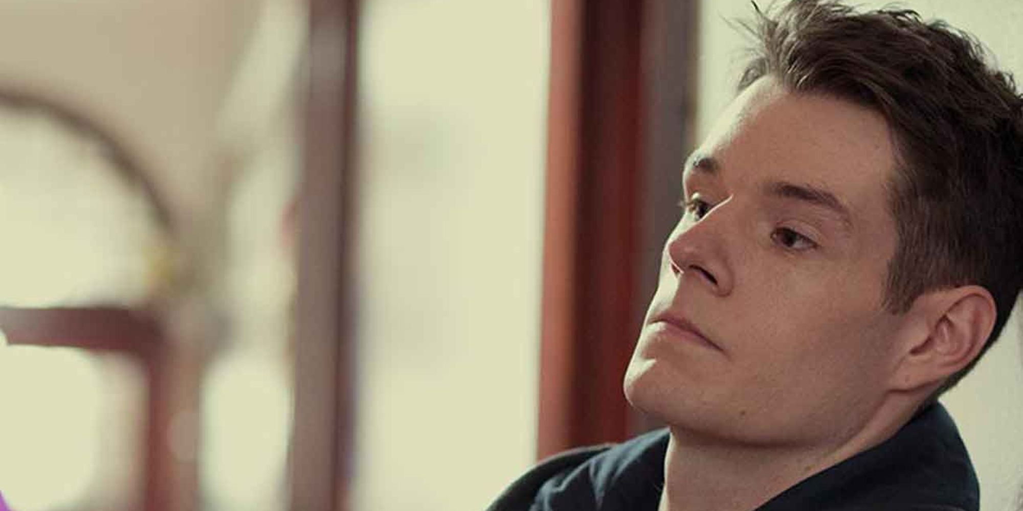 Adam Groff looking sideways in Sex Education