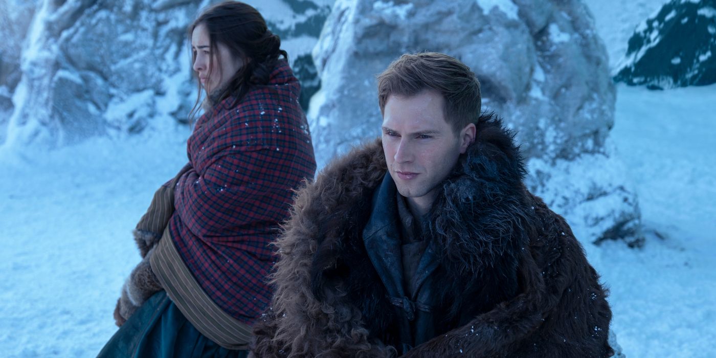 Nina and Matthias stand outside in the snow in Shadow and Bone.