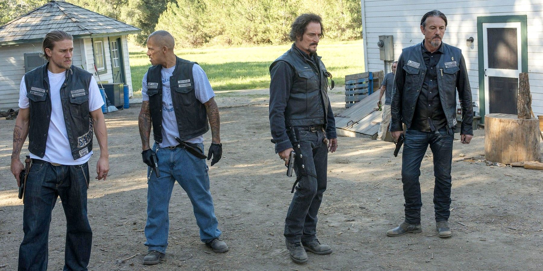 Jax, Happy, Tig, and Chibs hold their guns outside in Sons of Anarchy