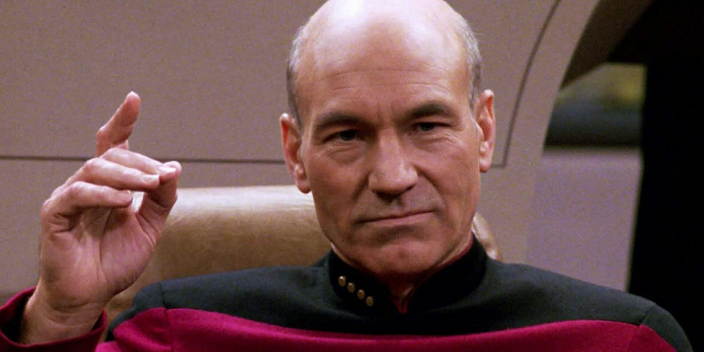 Captain Picard raises a hand to give a command from Star Trek The Next Generation