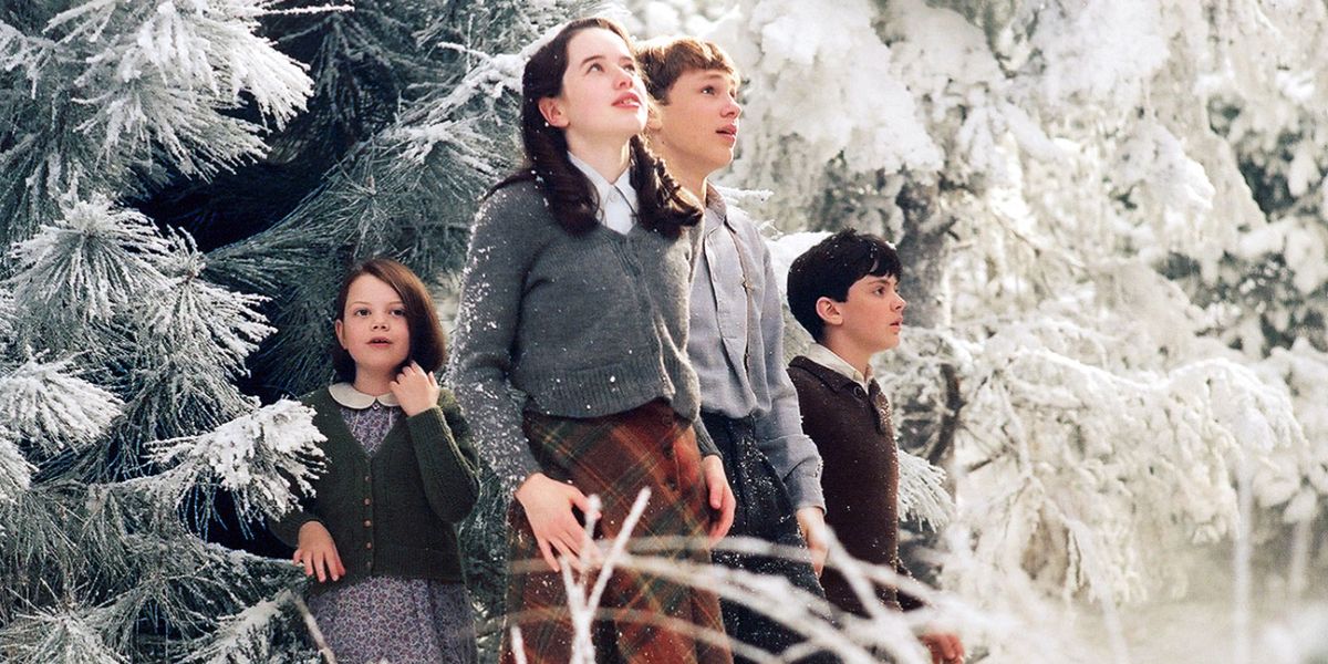 the Pevensie siblings step through the forest into narnia