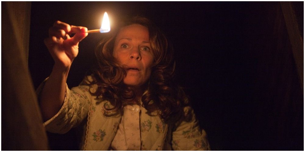 The Conjuring Woman Holding A Lit Match In The Dark