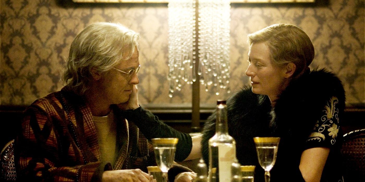 The Curious Case of Benjamin Button with Brad Pitt and Tilda Swinton's characters talking at a dining room table.