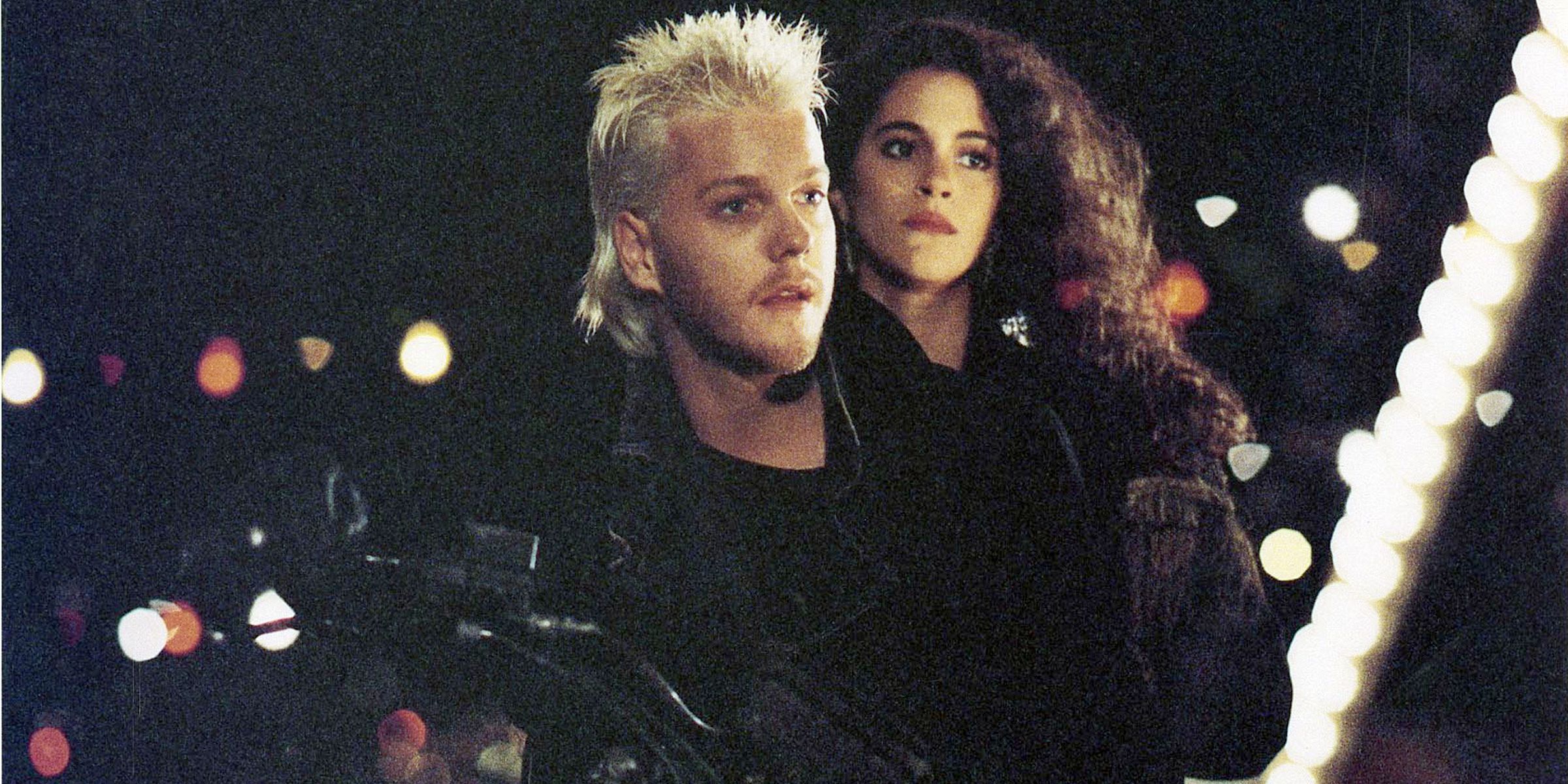 Kiefer and Jami on a bike in The Lost Boys 