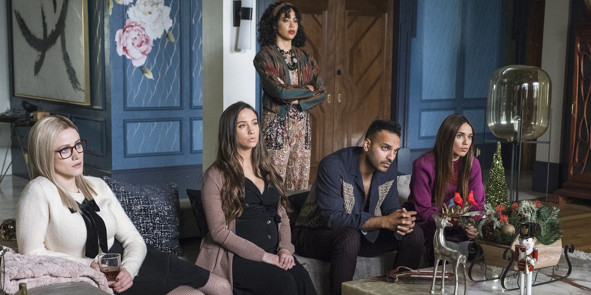 Alice, Julia, Penny, and Margo sit on the couch with Kady stands behind them in The Magicians